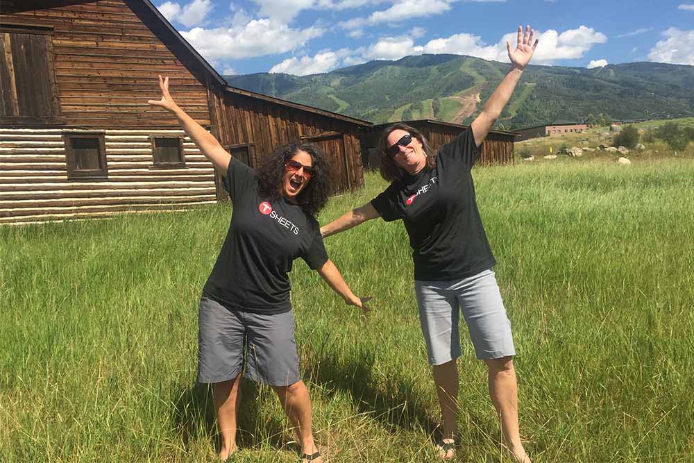 co-founders of Singletrack Bookkeeping in front of barn with a mountain background