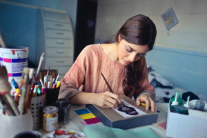 Female business owner painting