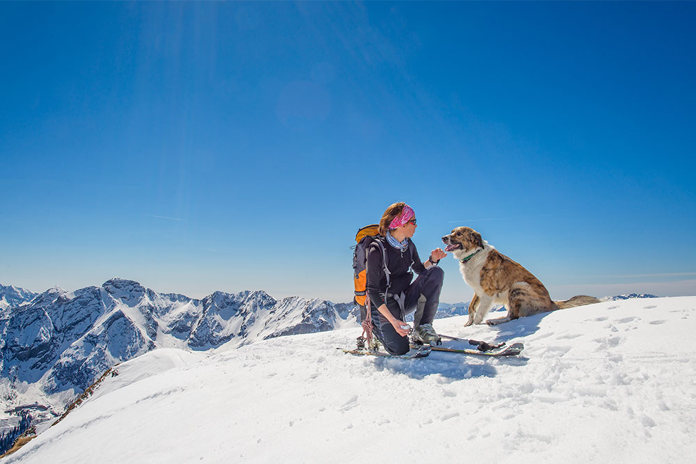 Women hiking with dog while pet sitting